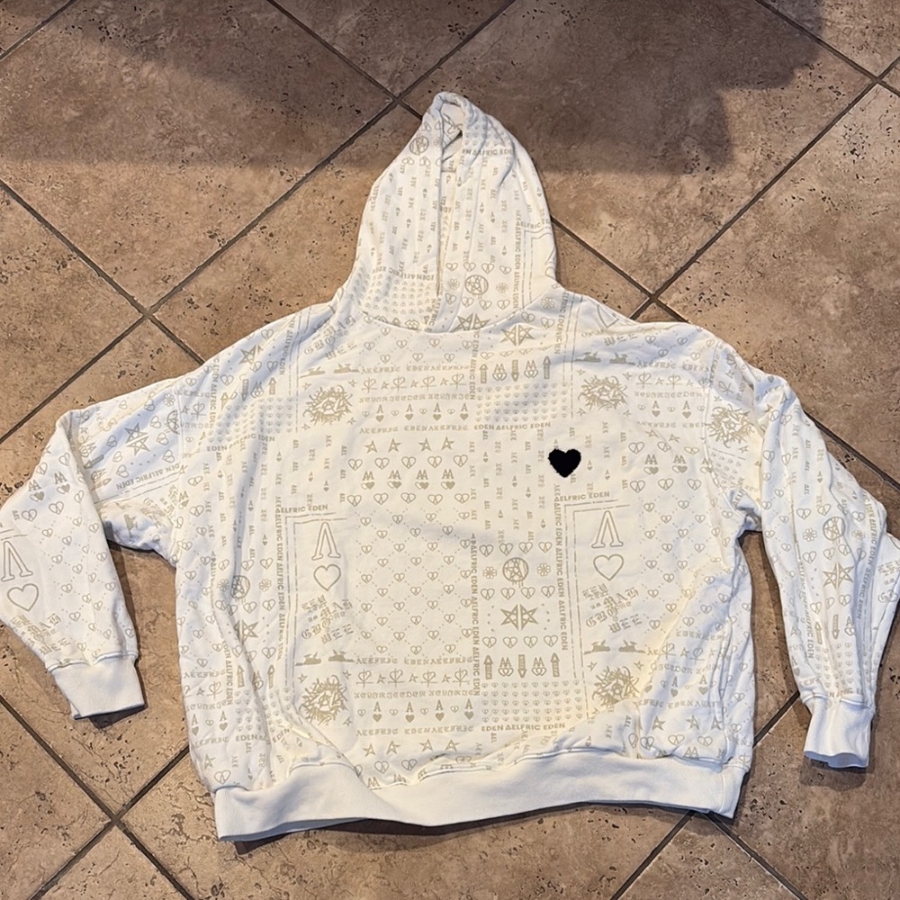 White Patterned Sweater with Heart Emblem